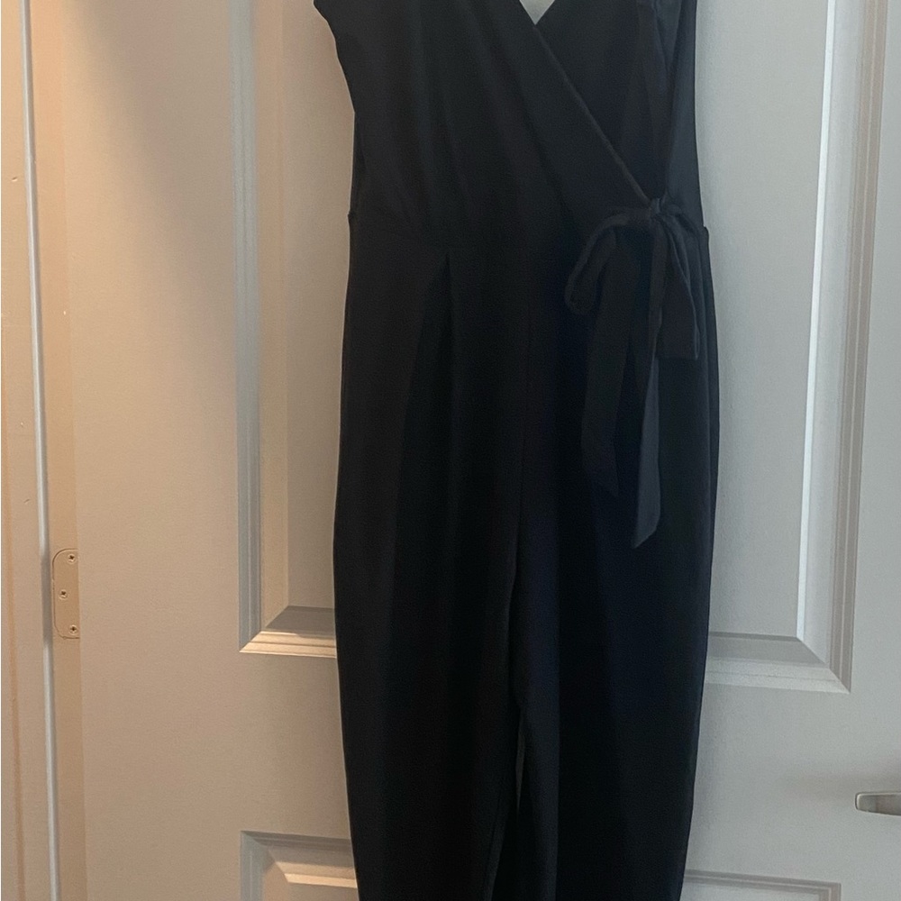 Description of a black jumpsuit that has a tie on the side